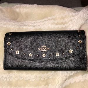 Black coach wallet. 8inx1inx4in gold design.